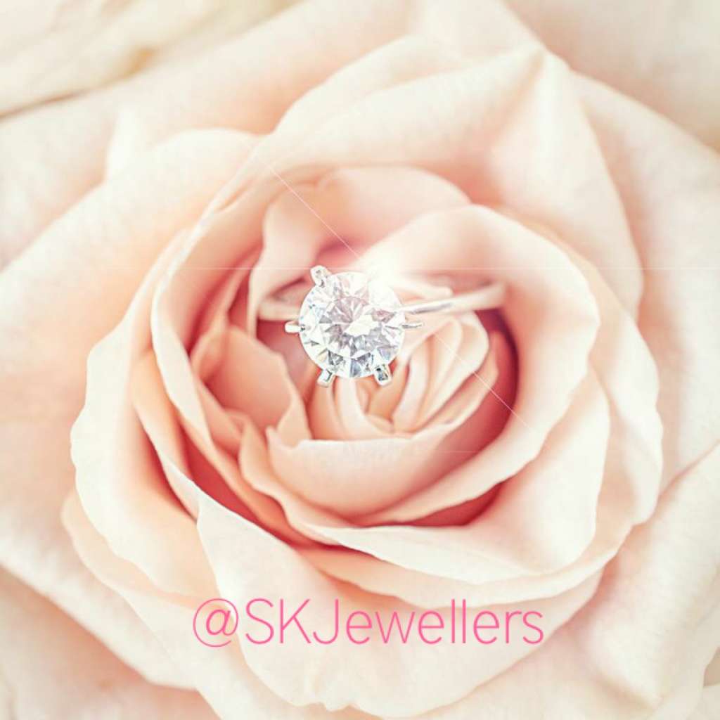 solitaire diamond engagement ring with pink rose