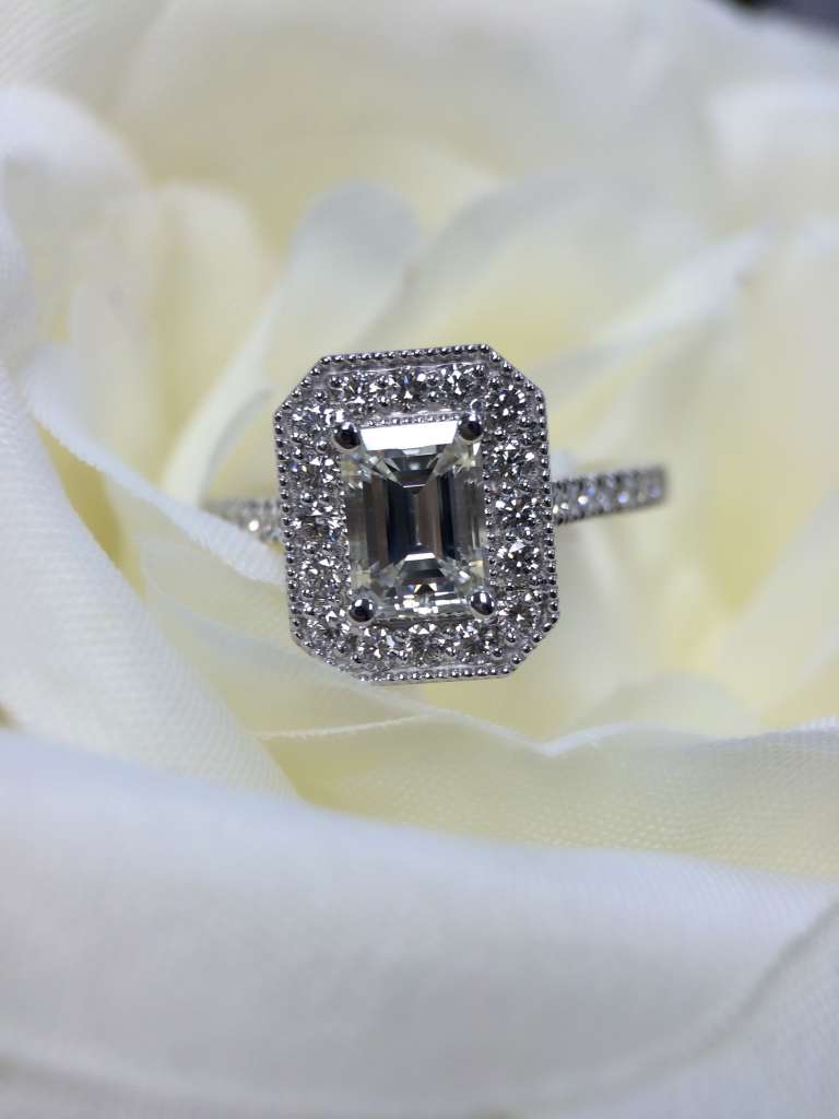 Emerald cut diamond halo engagement ring