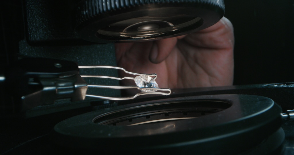 jeweller inspecting diamond